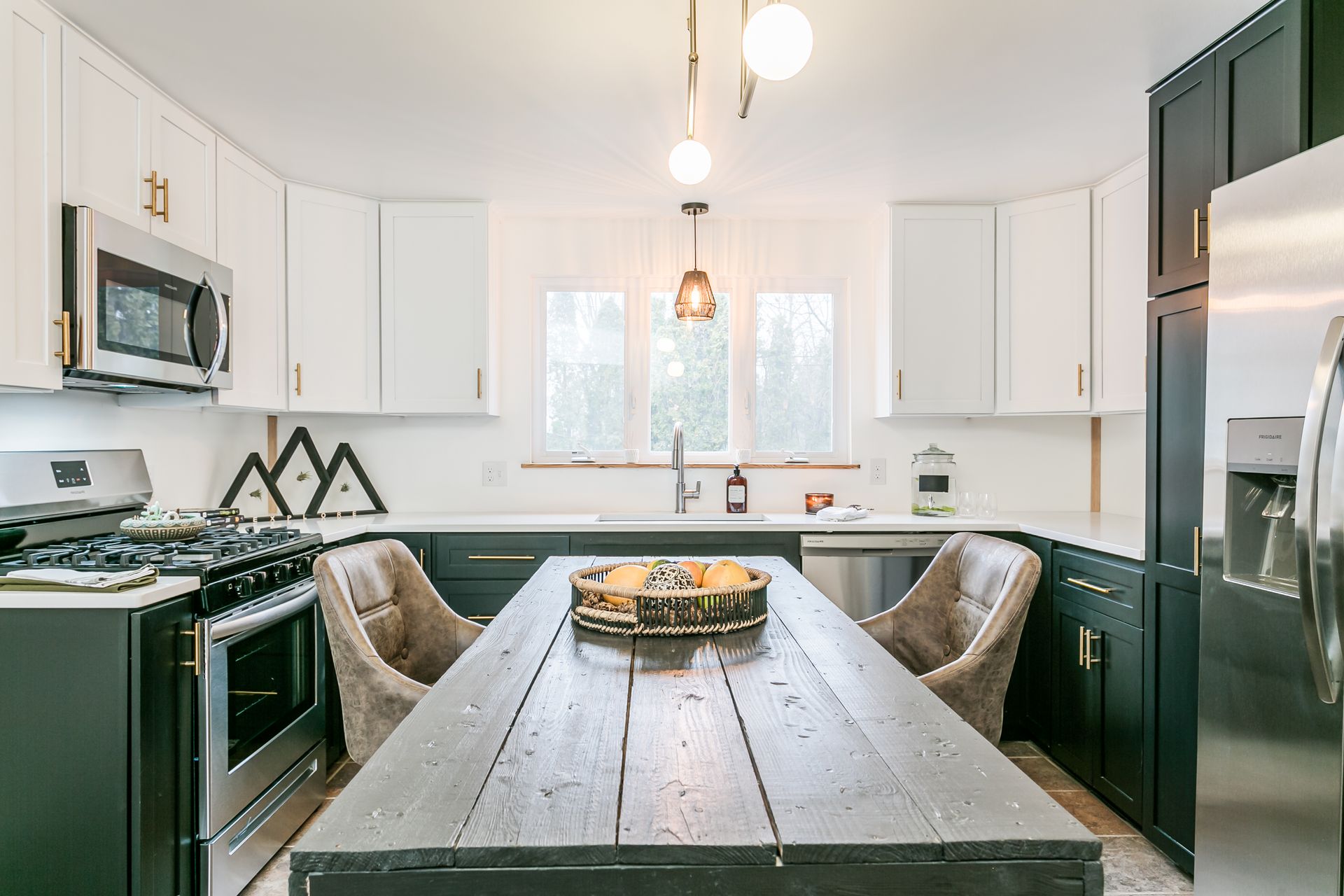 A kitchen with a large wooden table and chairs