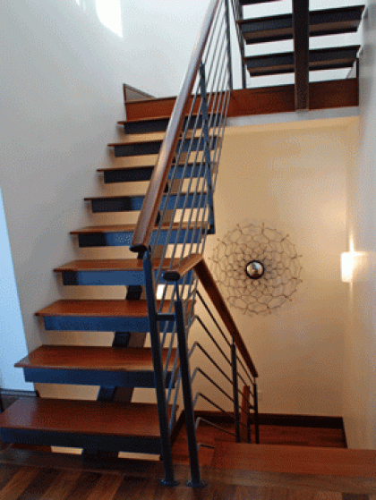 A staircase with wooden steps and a metal railing