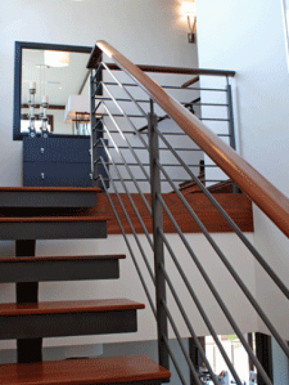 A staircase with a metal railing and wooden steps