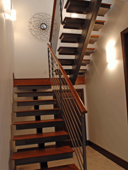 A staircase with a metal railing and wooden steps