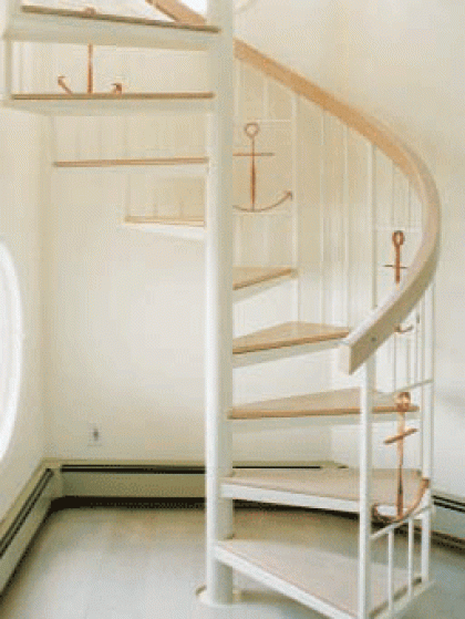 A spiral staircase with an anchor on the railing