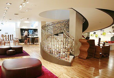 custom white spiral staircase with golden brown railings