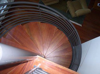 wood spiral stair with metal post and rail