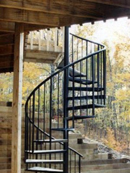 A spiral staircase leading up to a wooden deck