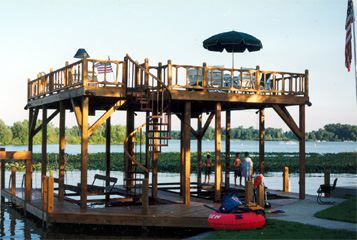 A large wooden deck overlooking a body of water