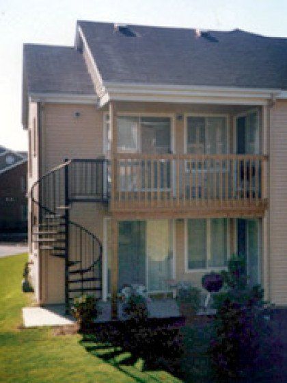 A house with a spiral staircase and a balcony