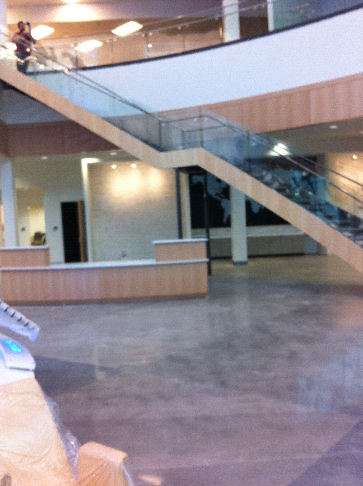 A staircase in a building with a glass railing
