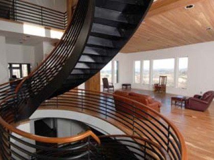 custom wood spiral stair with black metal railing