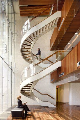 white spiral stairs with glass railings in an office building