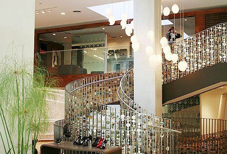 A spiral staircase in a building with a table in front of it