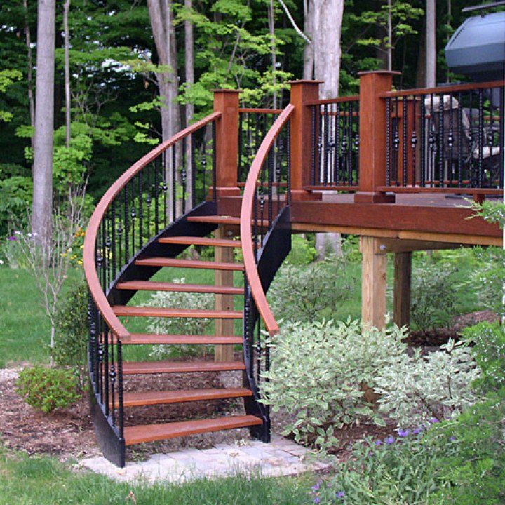 A wooden deck with a spiral staircase leading up to it