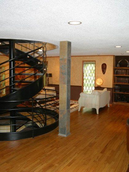 A living room with a spiral staircase in the middle