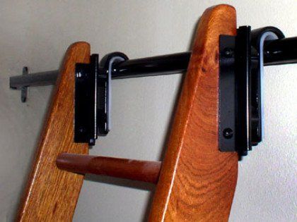 A wooden ladder with a metal rail attached to it