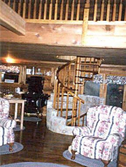 A living room with a spiral staircase and chairs