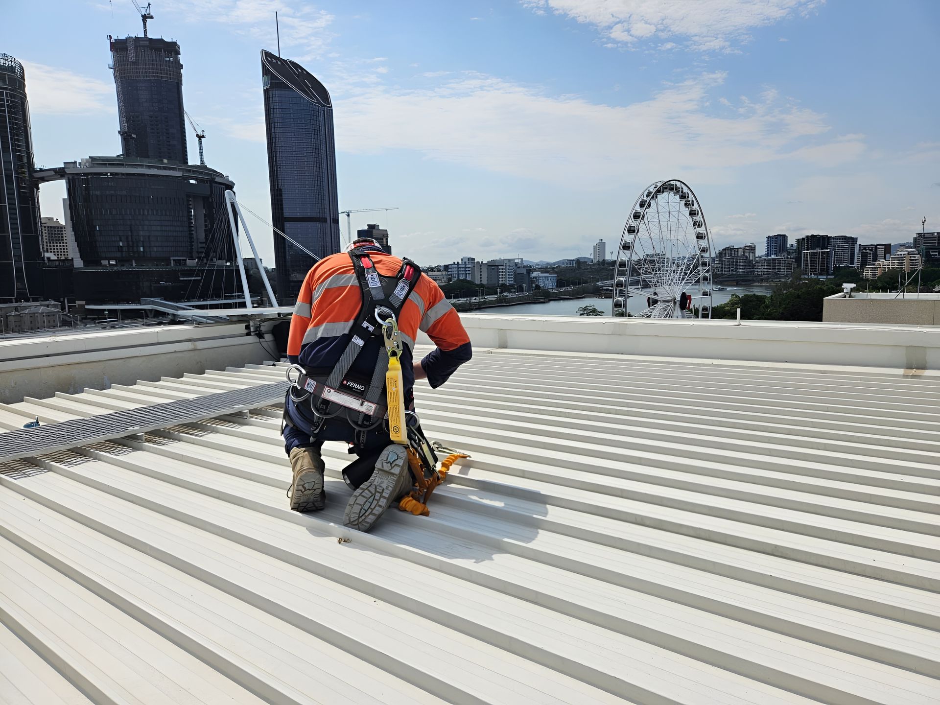 Person on Roof Wearing Safety Gear — Australian Asset Compliance in Brisbane, QLD
