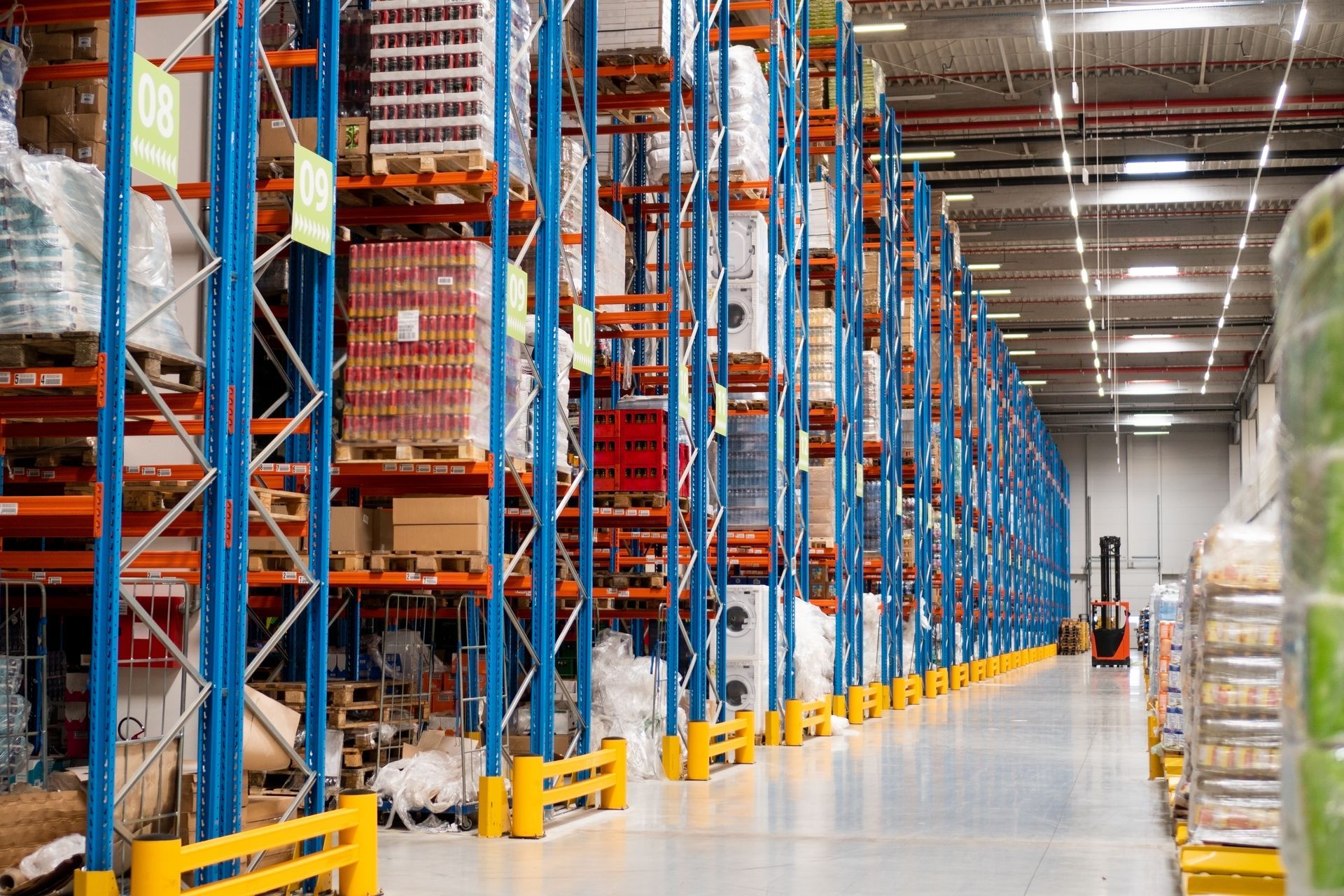 Warehouse Interior With Tall Blue Shelving — Australian Asset Compliance in Mackay, QLD