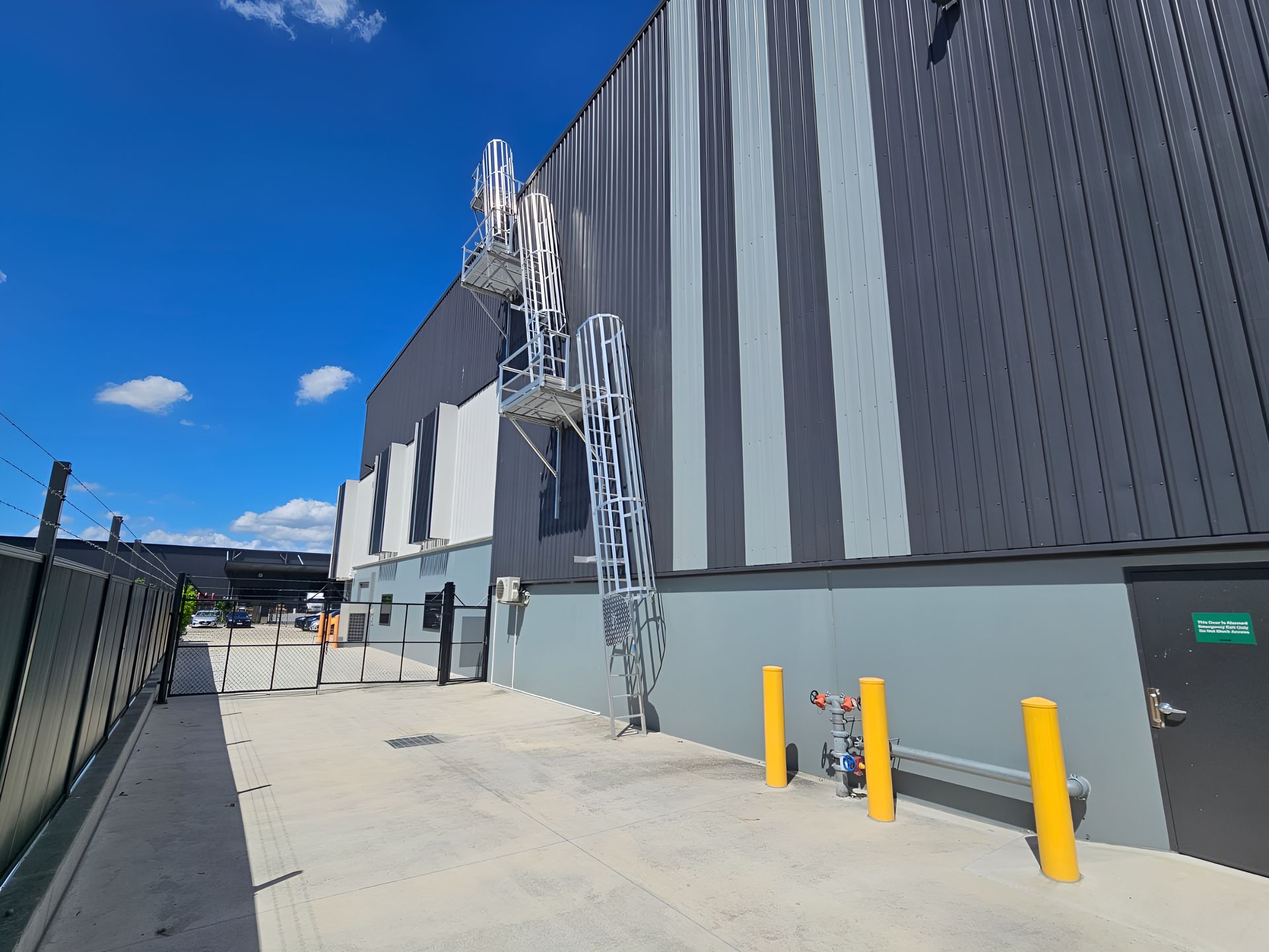 Exterior of a Building With a Metal Ladder Attached — Australian Asset Compliance in Glanmire, QLD