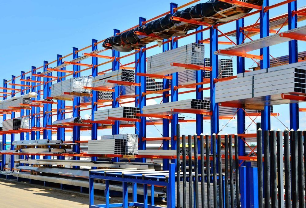Metal Storage Racks Loaded with Various Silver and Black Metal Beams — Australian Asset Compliance in Glanmire, QLD