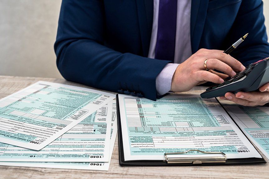 man working on tax forms