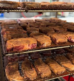A bunch of meat is sitting on a wire rack.