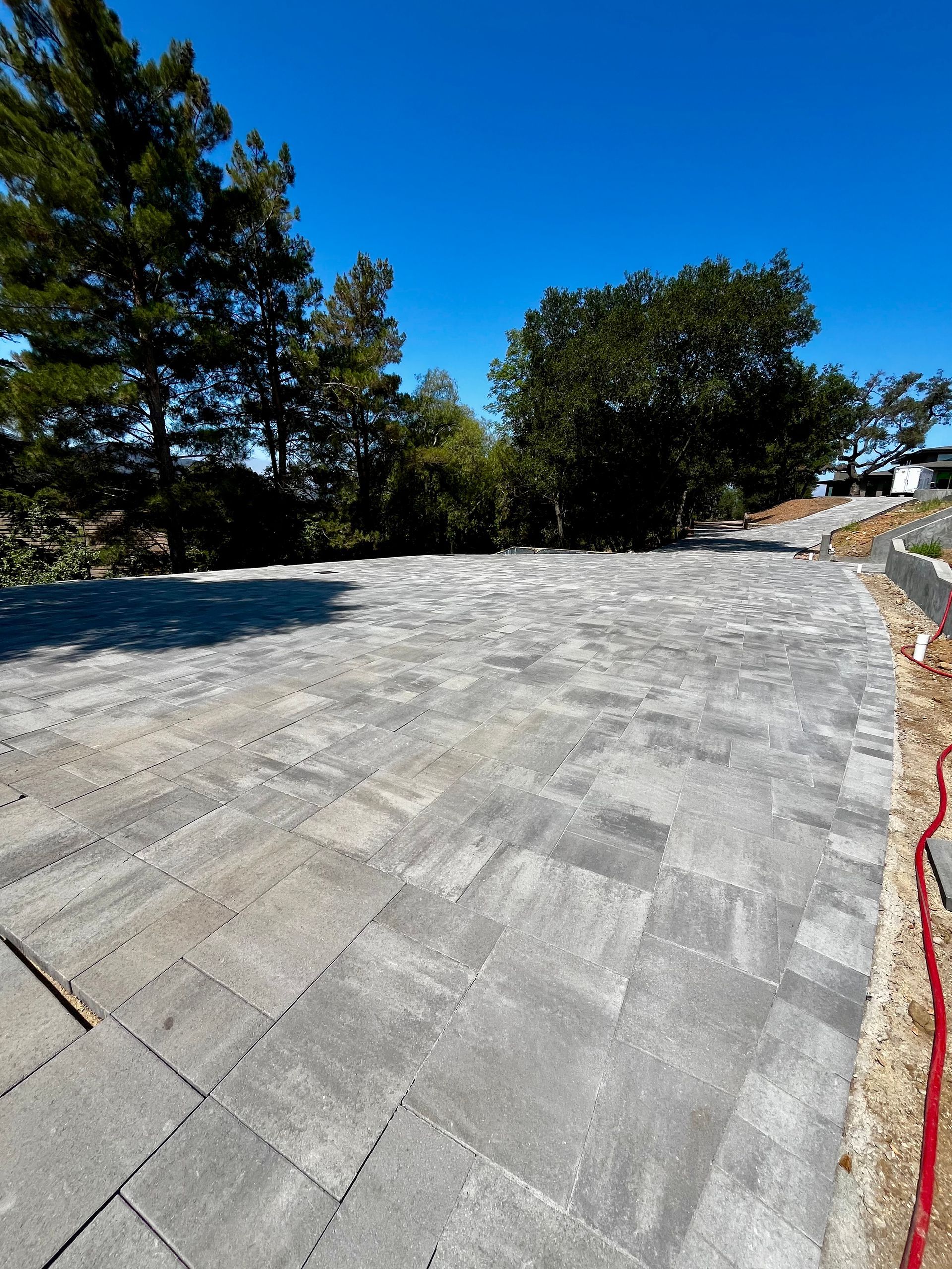 New gray roof under construction beside trees and blue sky