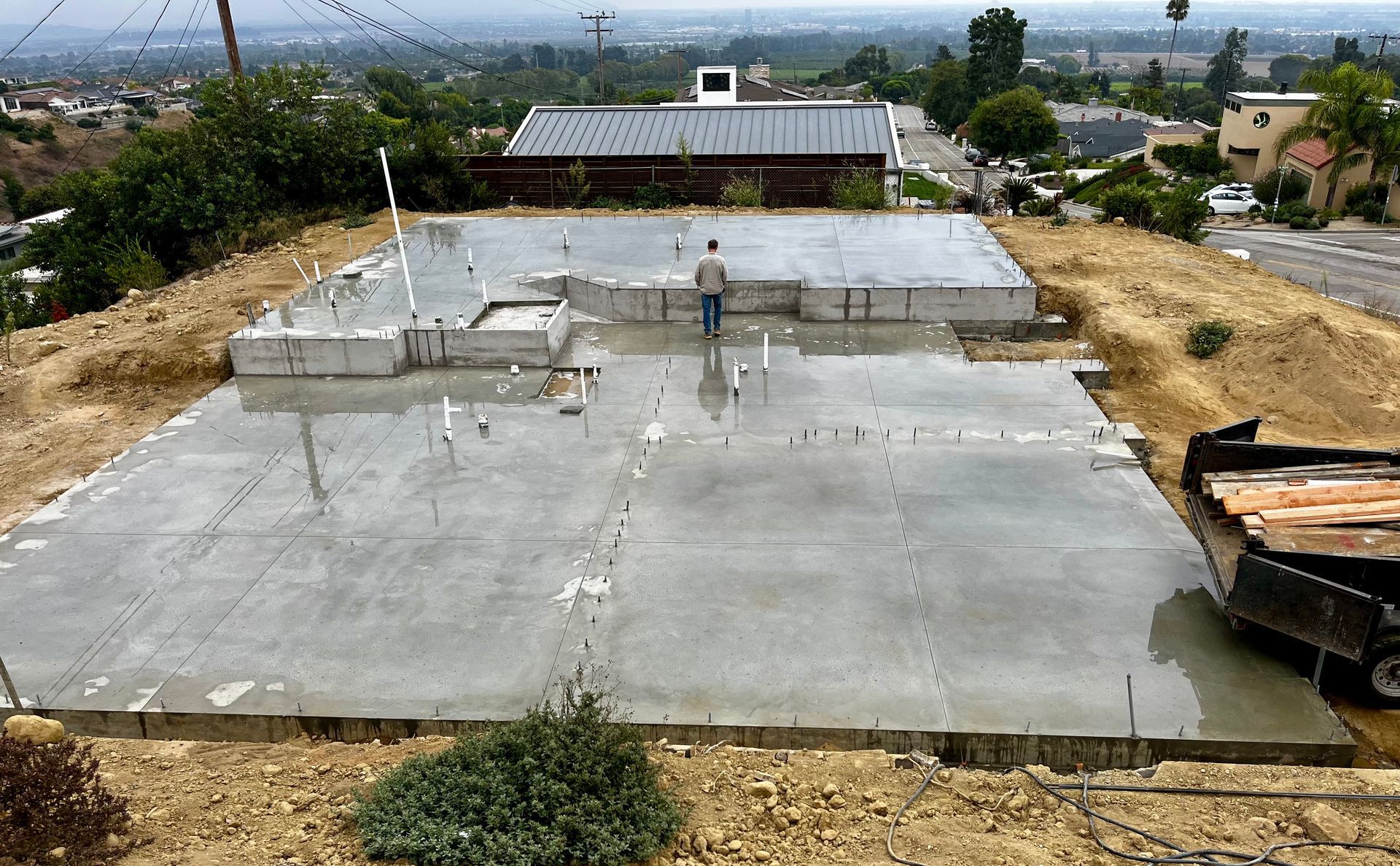 A concrete foundation is being built in a residential area.