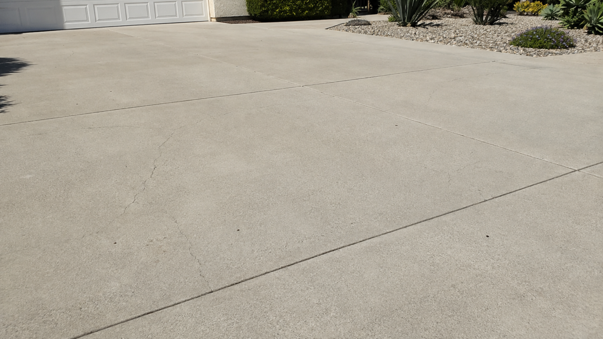 Thin hairline cracks on a concrete surface from minor shrinkage