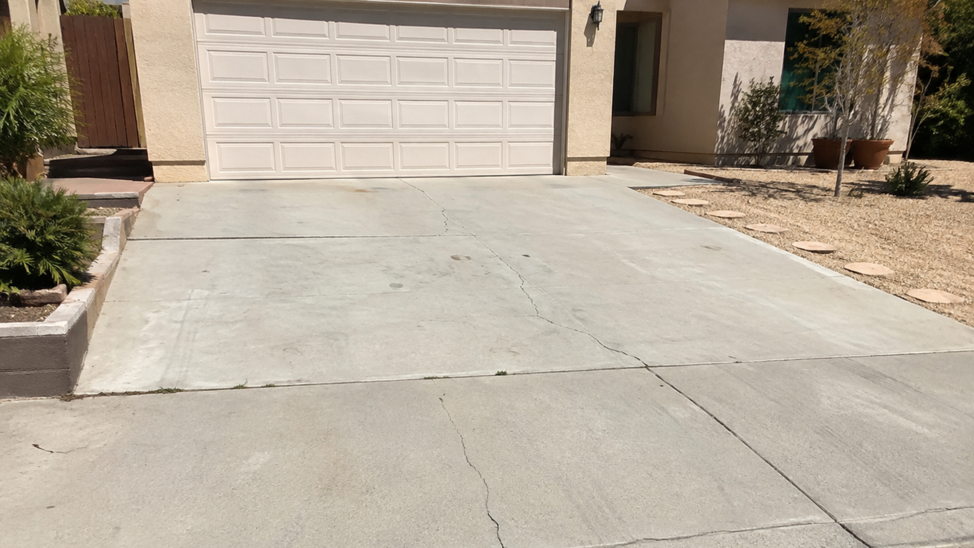 Cracked concrete driveway surface at a Southern California home