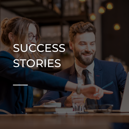 Business meeting scene with two professionals smiling and discussing a document, overlaid text “SUCCESS STORIES”
