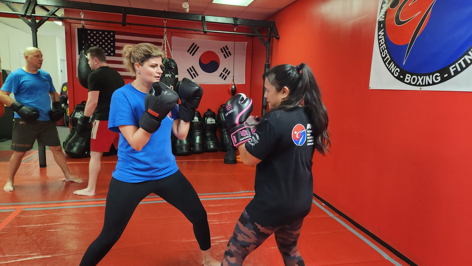 A group of people are practicing martial arts in a gym.
