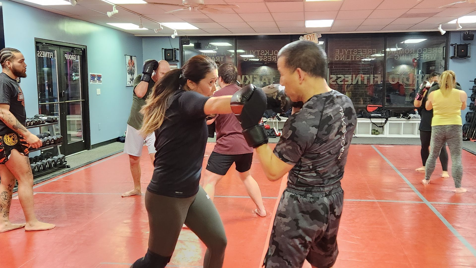 A group of people are boxing in a gym.