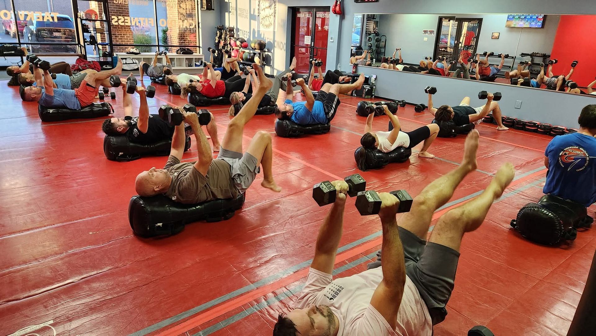 Goup Fitness students lifting weights on floor