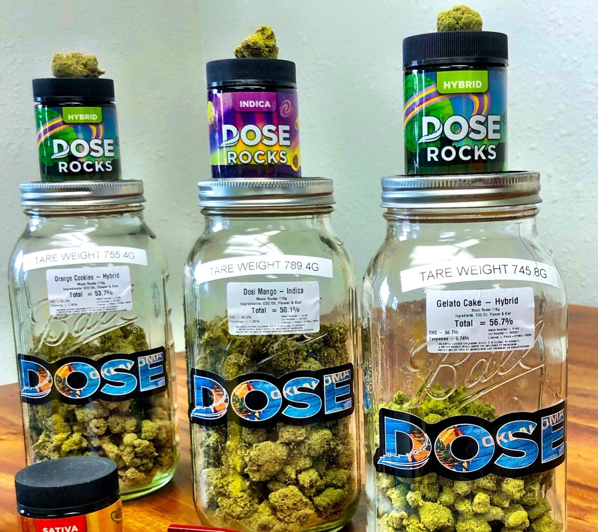 Three jars of dose rocks are sitting on a table