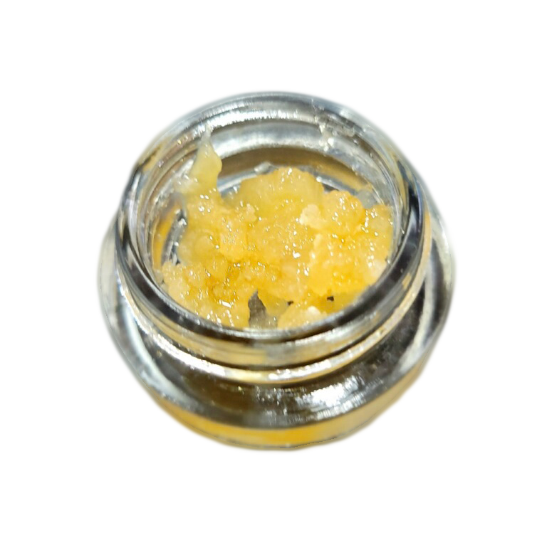 A small jar filled with a yellow substance on a white background