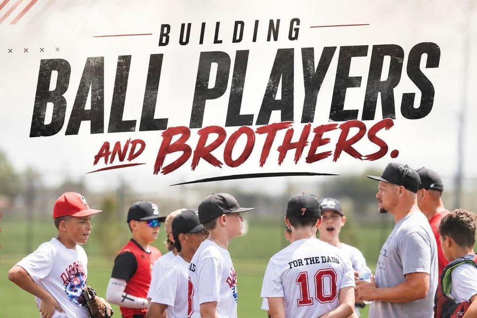 Youth baseball team, the Vikings, pose for a team photo on a baseball field. Players in gray and red uniforms kneel and stand, doing a dab pose.
