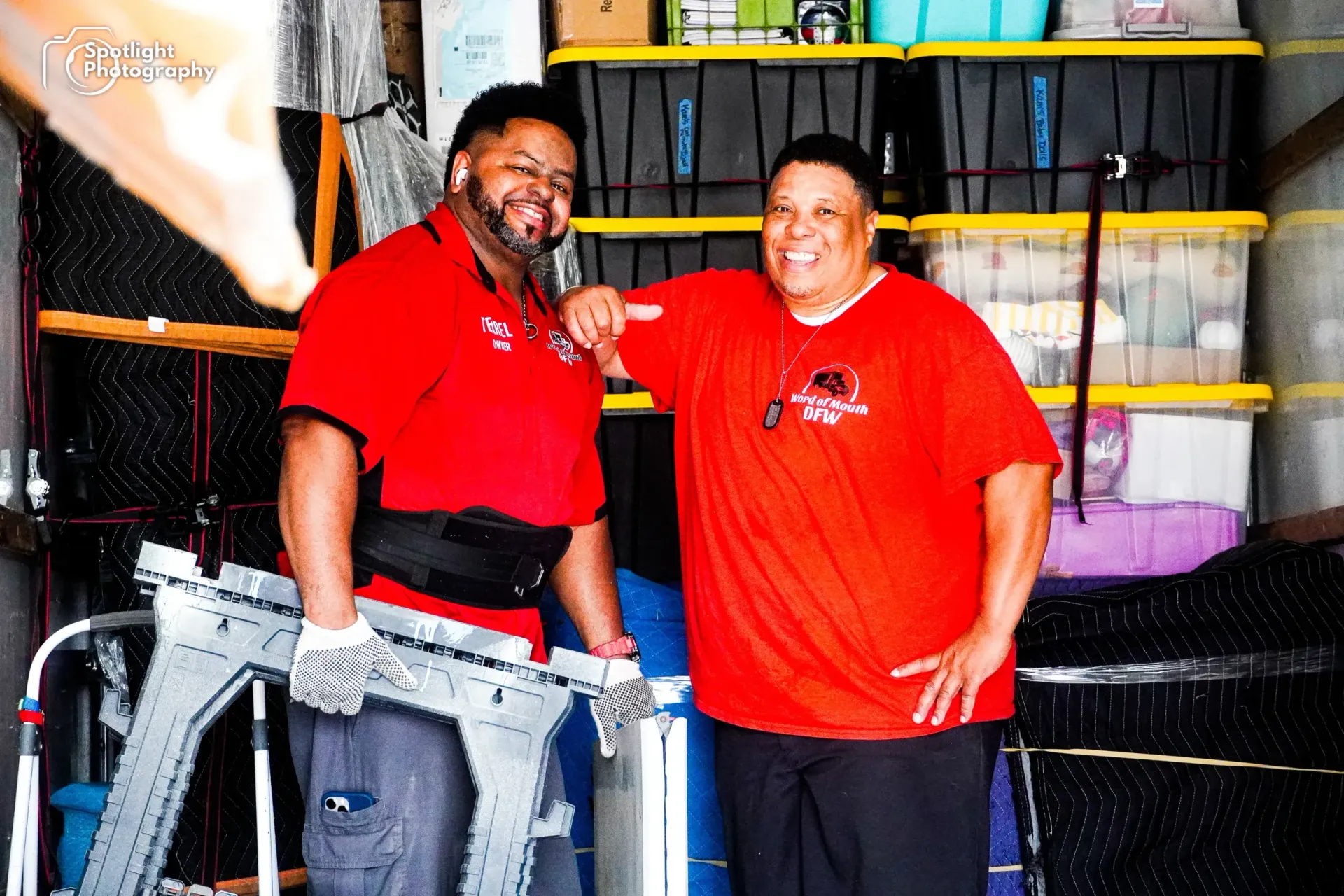 Two men in red shirts are standing next to each other