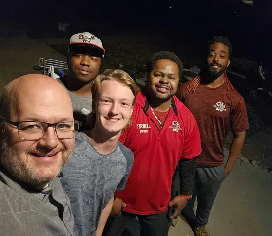 A group of young men are posing for a picture together