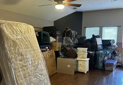 A living room filled with lots of furniture and boxes.