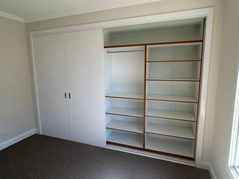 Closet With White Sliding Doors Open — JRB Joinery In Kew, NSW