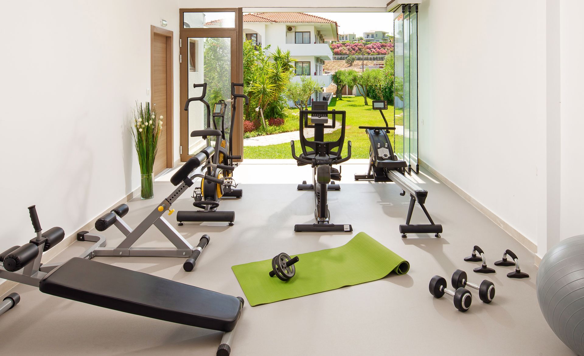 home gym setup featuring various exercise equipment