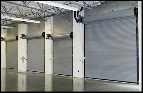 A row of garage doors are lined up in a warehouse.