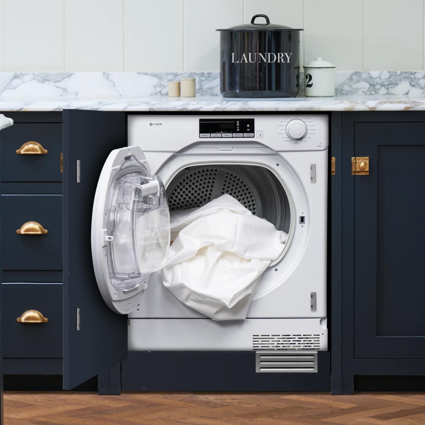 A washer and dryer in a kitchen with the door open