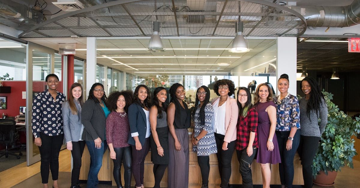 A group of women are posing for a picture in an office.