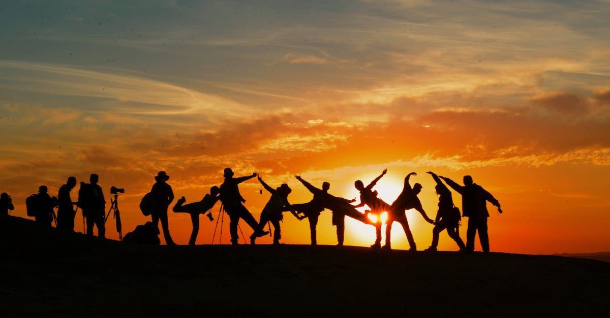 A group of people are posing for a picture at sunset.