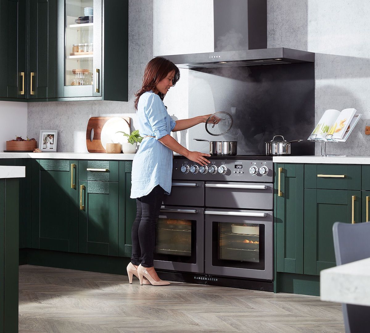 A kitchen with a blue stove and a clock on the wall.