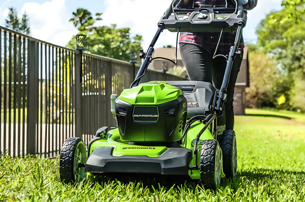 A Green Lawn Mower is Sitting on Top of a Lush Green Lawn — Diamond Service Centre In Lismore, NSW