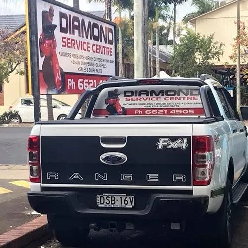 A White Ford Ranger Truck is Parked in Front of a Sign  — Diamond Service Centre In Lismore, NSW