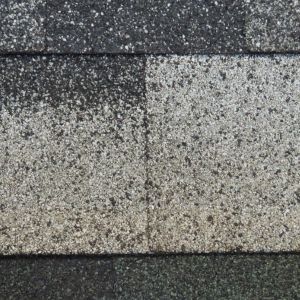 Close-up of a speckled gray concrete surface with horizontal dark bands.
