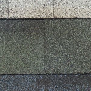Close-up of three textured horizontal stone bands in gray and green-gray.