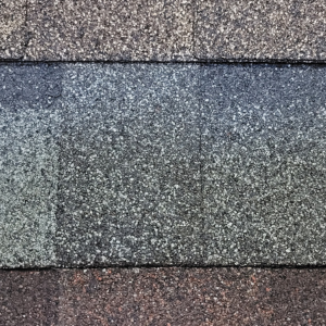Close-up of gray and reddish-brown shingle roof tiles in horizontal rows